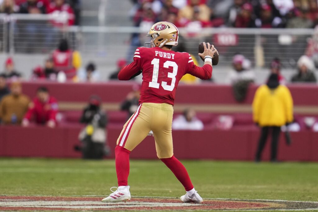 Brock Purdy, San Francisco 49ers quarterback, throwing a pass during the wild-card game against Seattle Seahawks